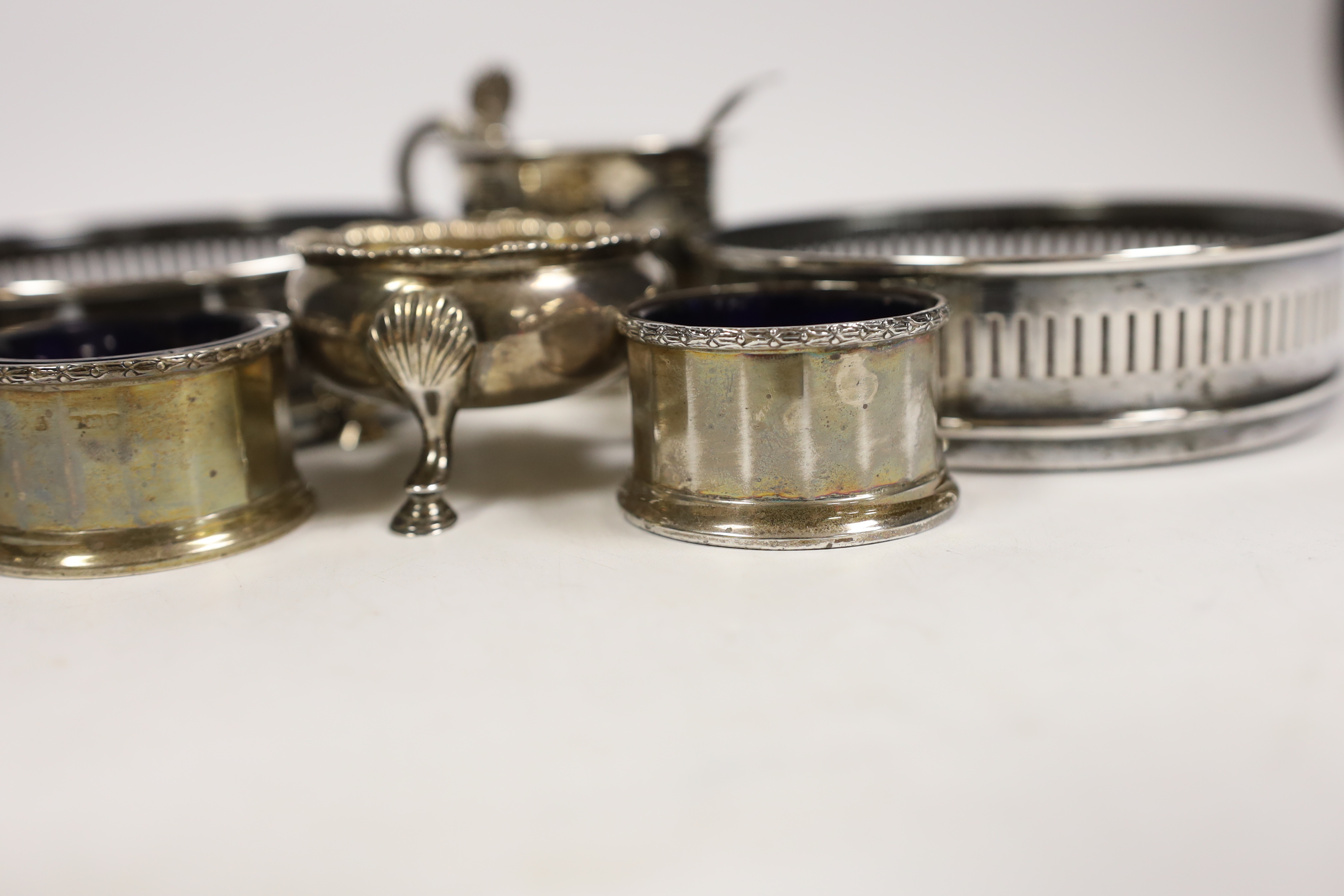 An early Victorian Scottish silver drum mustard, Edinburgh, 1844?, 7cm, two pairs of silver salts including pair by David & Robert Hennell, London, 1766 and a pair of silver plated wine coasters.